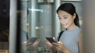 Geceleri cep telefonu kullanan bir kadın. 