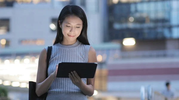 Vrouw die tablet pc in de stad — Stockfoto