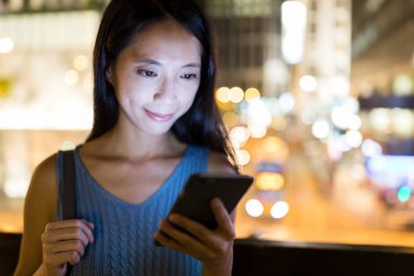 Geceleri smartphone üzerinde çalışan kadın 