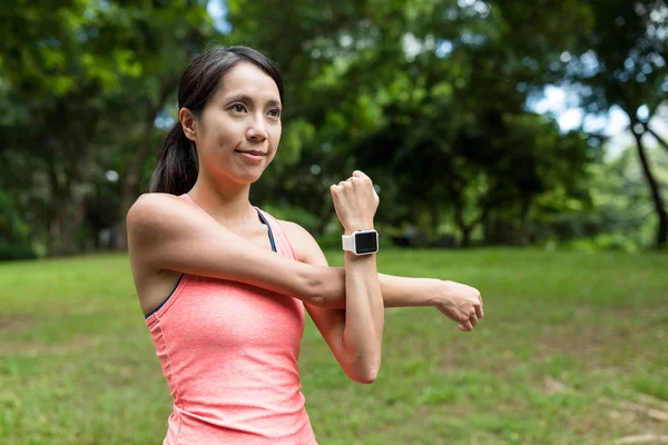 Sport woman using smart watch in park