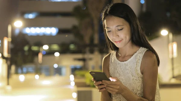 Woman sending text message on cellphone