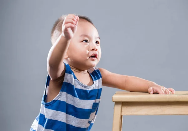 Little boy raising up hand — Stock Photo, Image