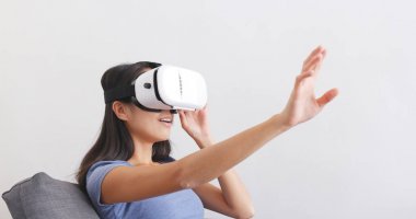 Divan Vr aygıtıyla izlerken kadın 
