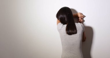 Kadın cry ve ayakta duvara karşı 