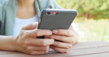 parkta cep telefonu kullanan kadın