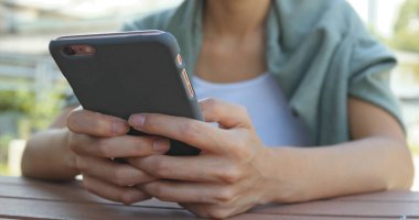 Parkta cep telefonu kullanan kadın 