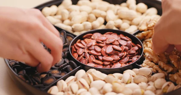 Hand taking snack from chinese snack tray box