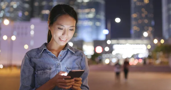 Mulher usando telefone celular em Hong Kong à noite — Fotografia de Stock