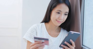 Cep telefonunuzun faturayı ödemeyi kredi kartı kullanan kadın