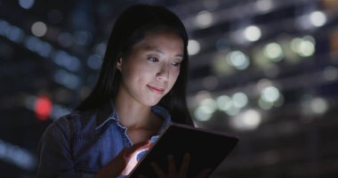 Geceleri dijital tablet bilgisayar kullanan kadın