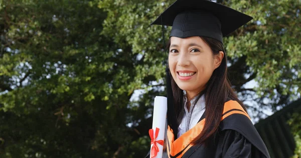 Woman get graduation and holding paper certificate