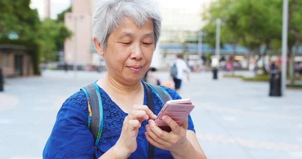 年配の女性が通りに携帯電話を使用して — ストック写真