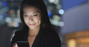 Geceleri cep telefonu kullanarak iş kadını