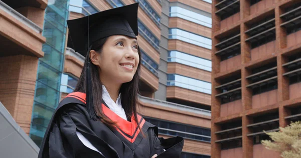 Cheerful confident graduation woman look far away