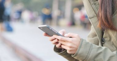 Elinde cep telefonu kullanan kadın