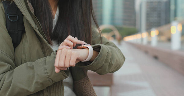 Woman using smart watch in the city 