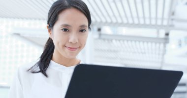 Dizüstü bilgisayarda çalışan Asyalı kadın