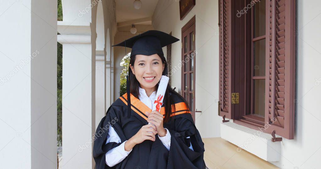 Excited woman get graduation and hold certificate 