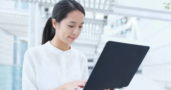Asian businesswoman works on laptop computer