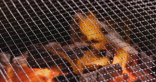 Barbecue Charcoal on fire with metal net