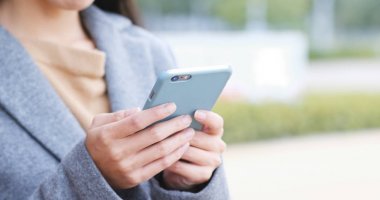 Kadın Şehir Parkı içinde hareket eden telefon üzerinde çalışıyor 
