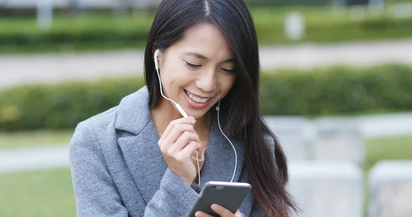 Woman talking on video call with mobile phone at outdoor