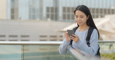 Asya açık, cep telefonu üzerinde çalışan kadın 