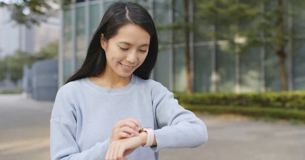 Travel woman using smart watch at outdoor