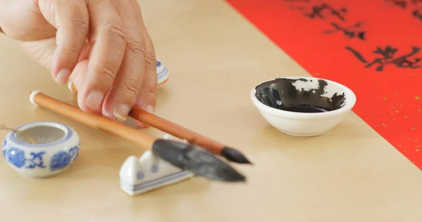 Dipping black ink for writing Chinese calligraphy