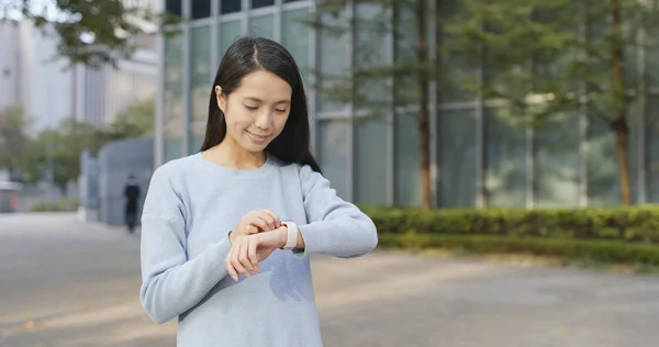 Woman using smart watch at outdoor