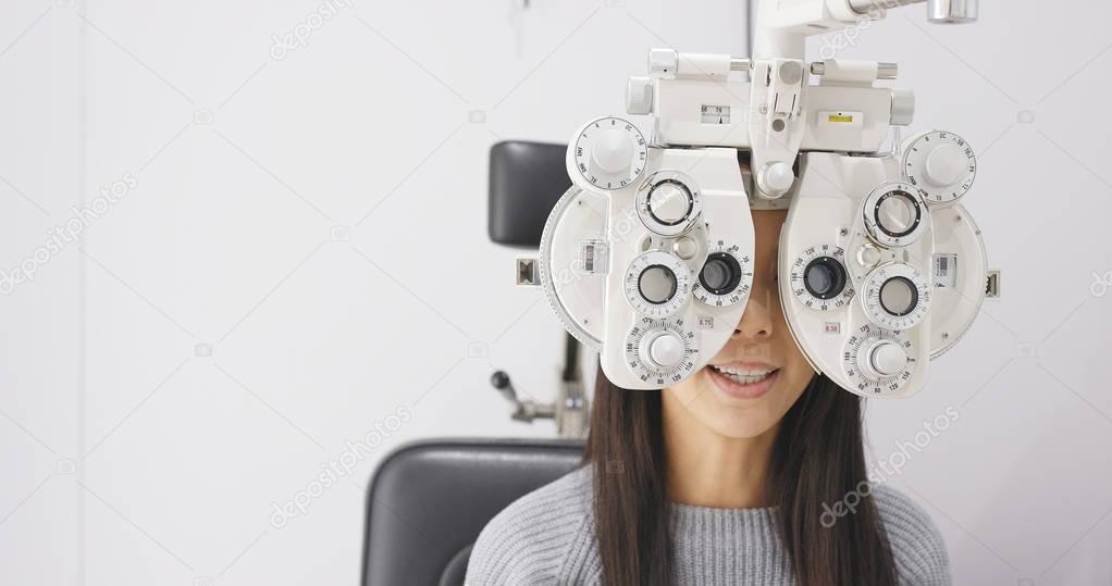 Asian Woman doing eye test 