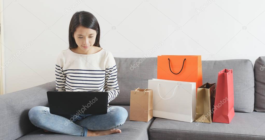 Woman shopping online on notebook computer at home 