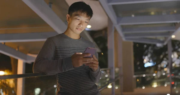 Man using mobile phone at night