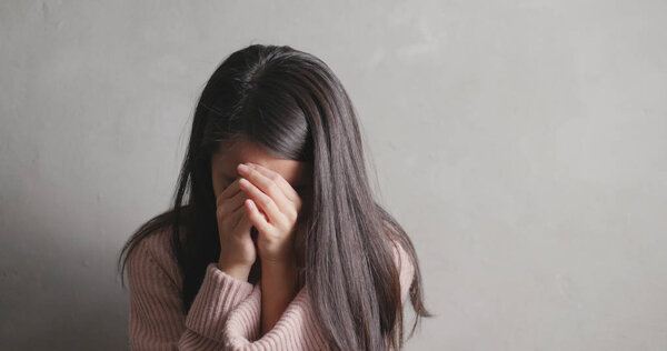 Depression woman crying over gray background  