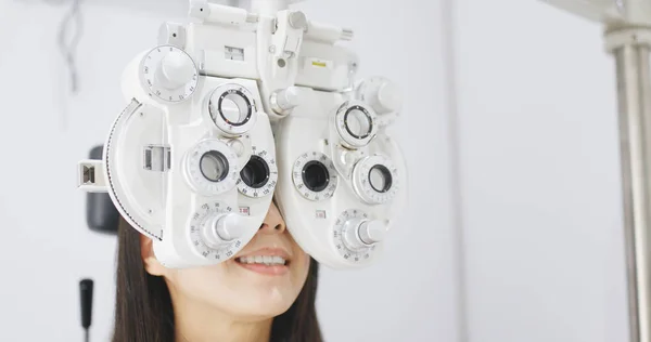 Asian Woman doing eye test in clinic