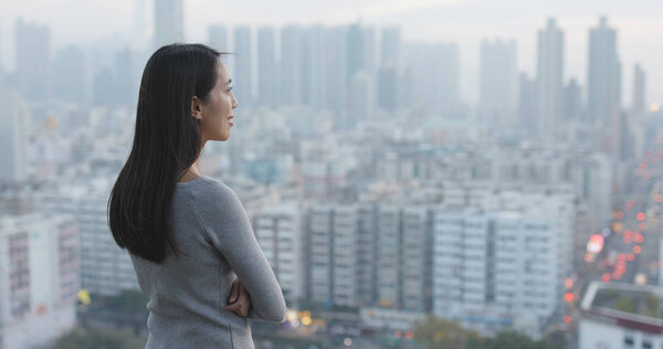 Confident woman looking at the city