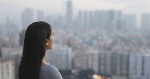 Confident woman looking at the city