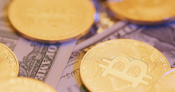 Bitcoins and USD banknotes close up