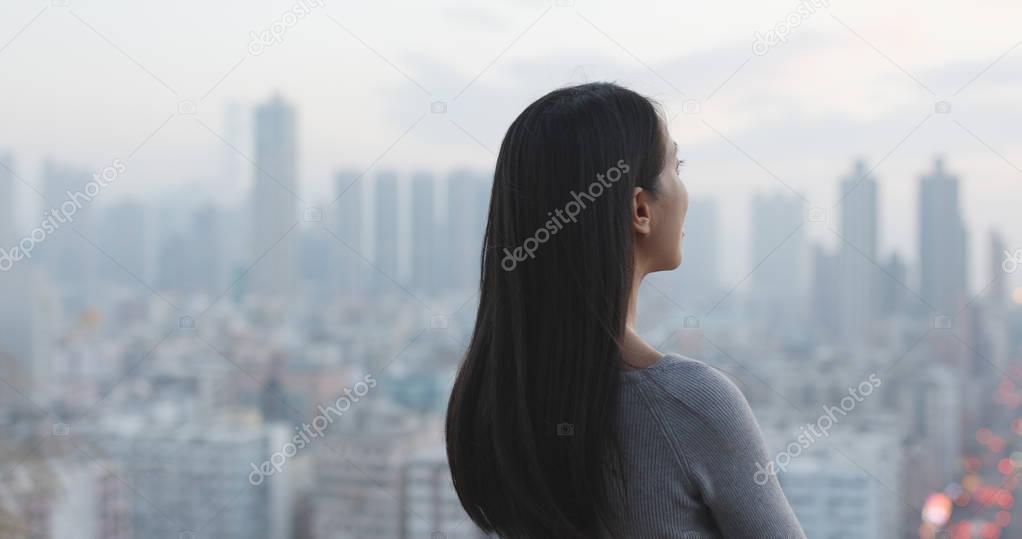 Confident woman looking at the city