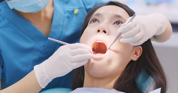 Doctor dentist working with patient in dental clinic