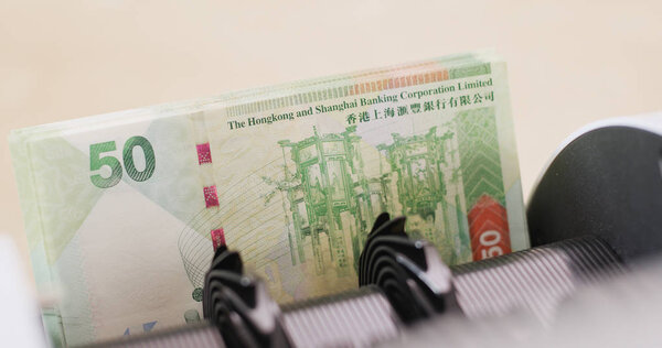 Hong Kong dollar on counting machine 