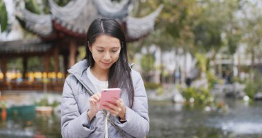 Cep telefonu kullanan Asyalı kadın. 