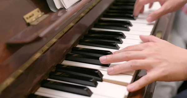 Man playing piano at home