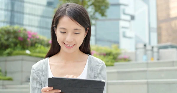 Businesswoman using tablet computer in city