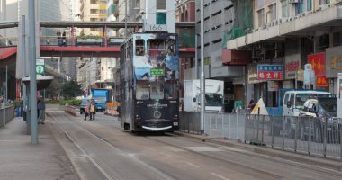 Sheung Wan, Hong Kong - 21 March, 2018: Hong Kong tramway passing the terminal  clipart