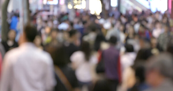 Blur of people crossing the street at night 