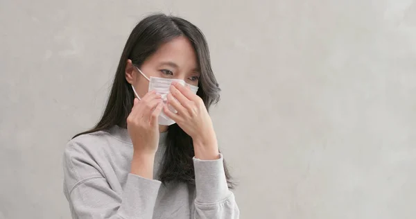 Woman coughing and wearing face mask