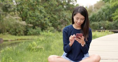 Kırsal kesimde cep telefonu kullanan genç kadın 