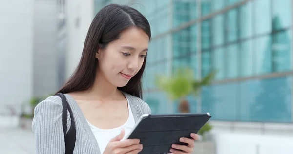 Woman work on tablet computer in city