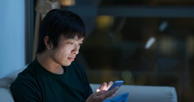 Man look at mobile phone at night